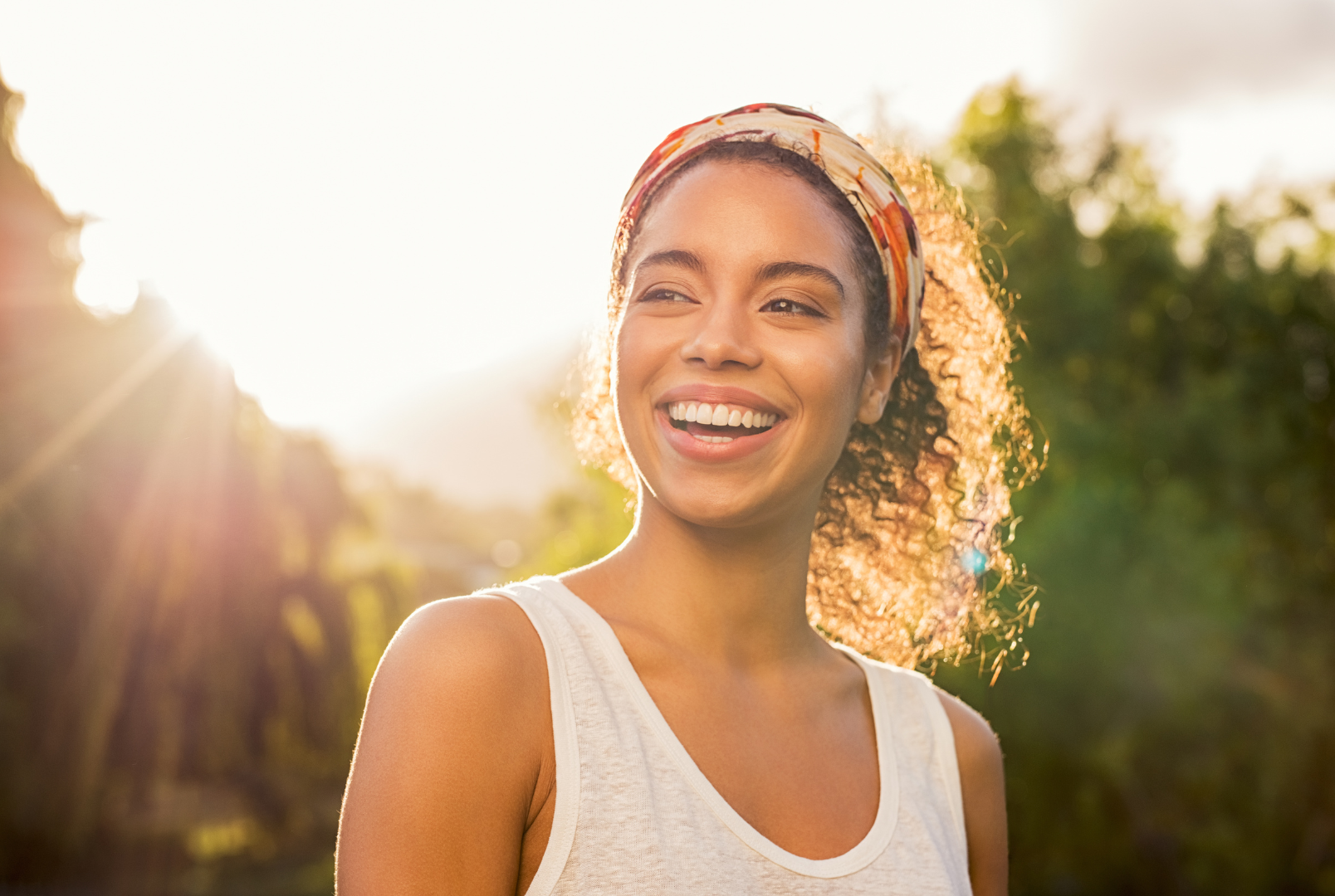Young woman smiling at sunset