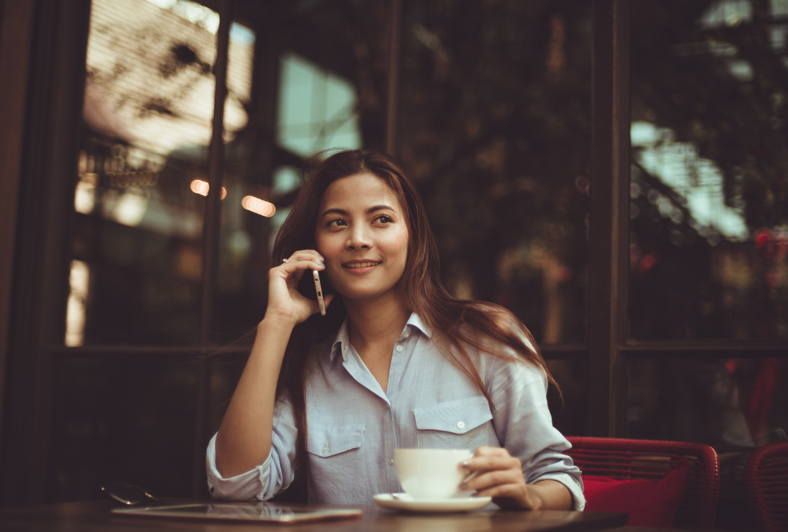 Woman on the phone drinking coffee