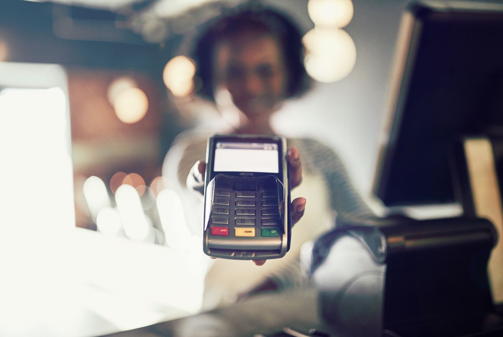 Employee holding credit card reader