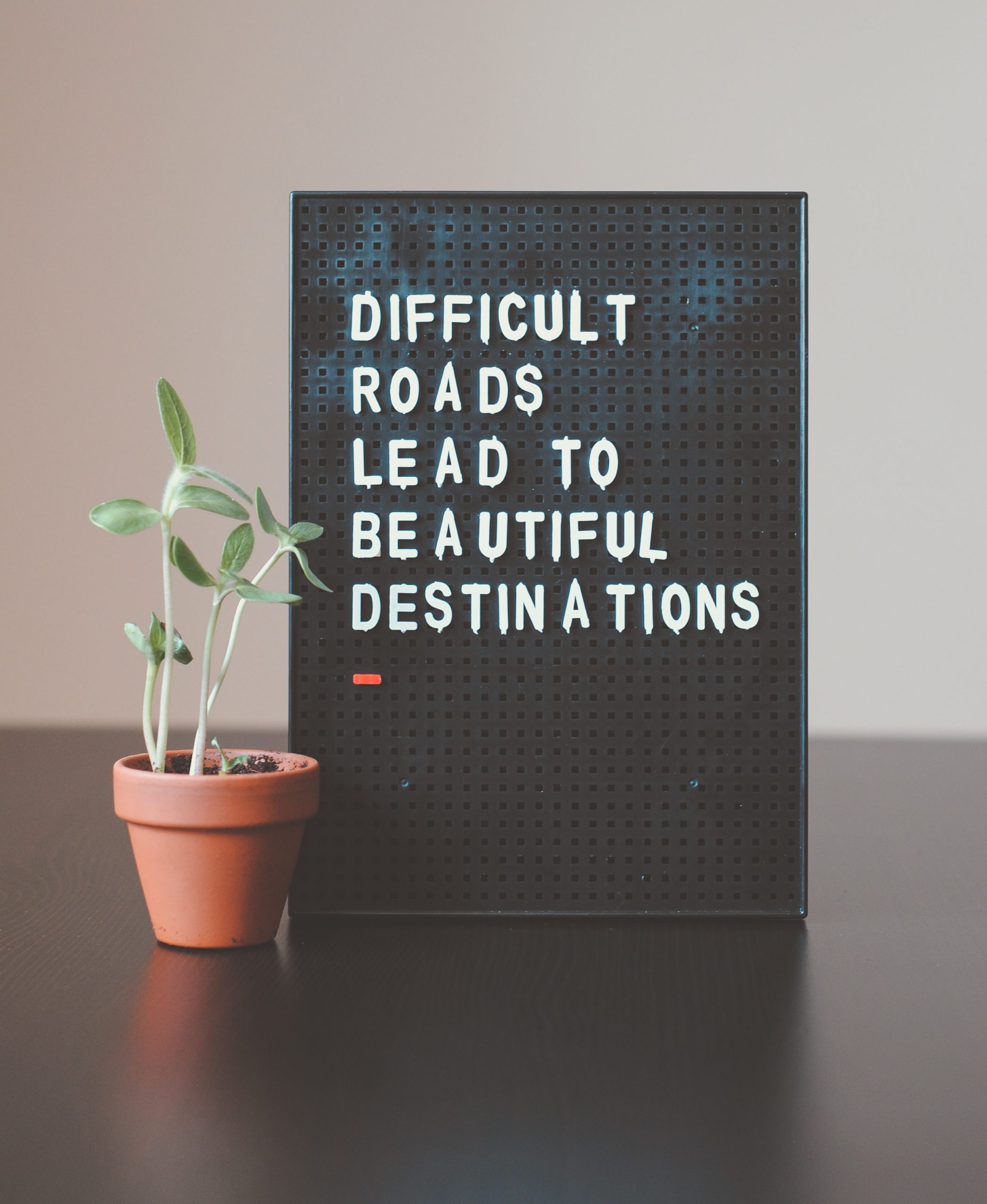sign saying difficult roads lead to beautiful destinations