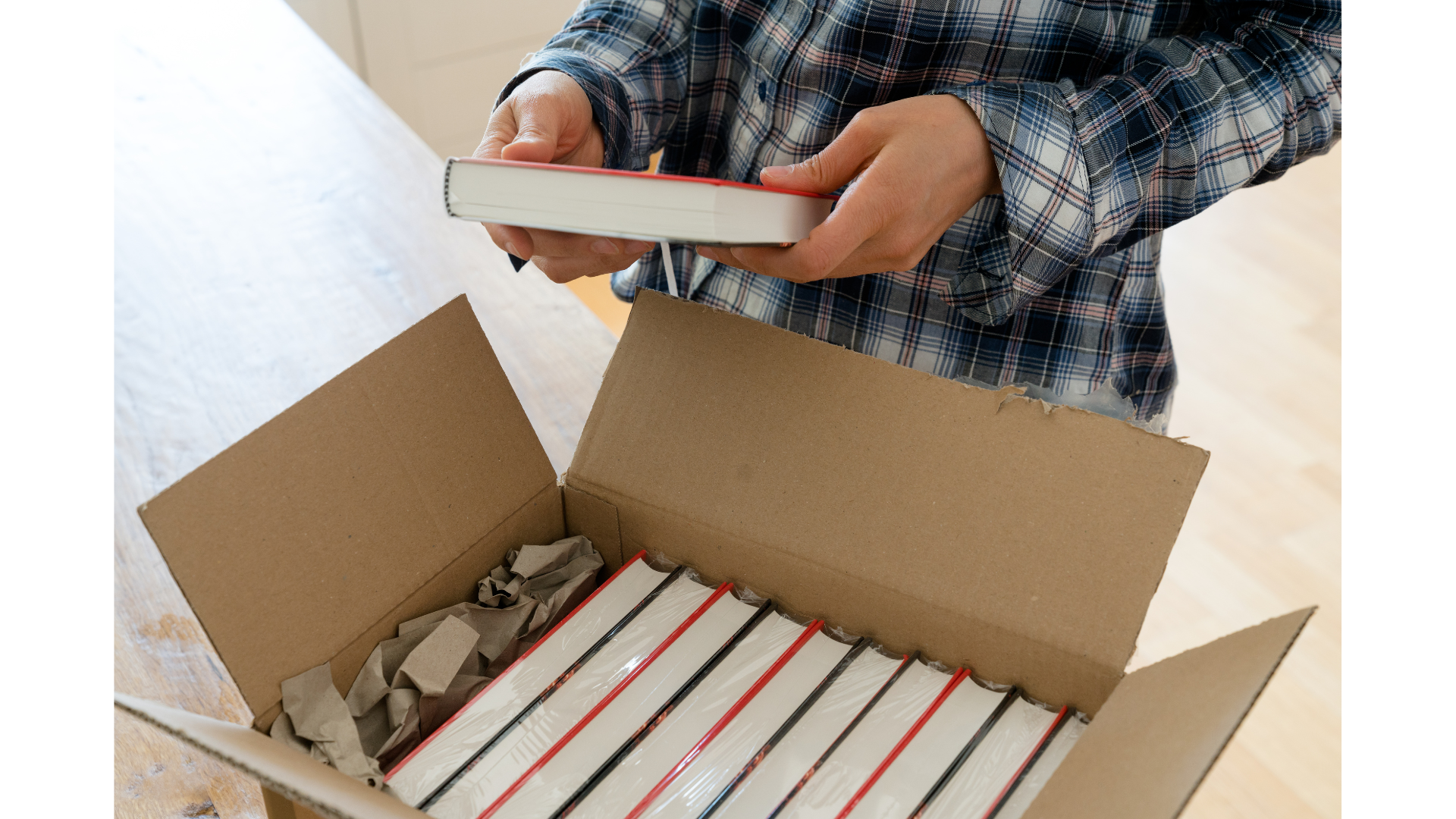Person opening a box of books