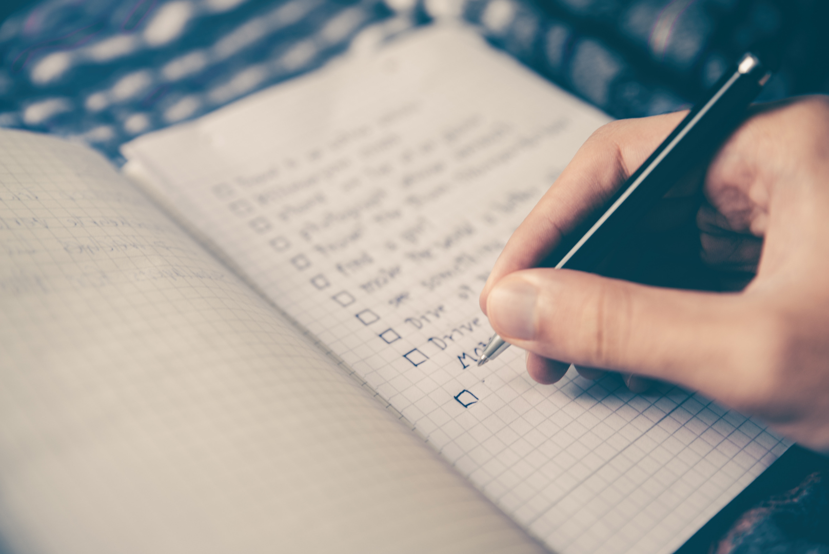 Writing checklist on notebook