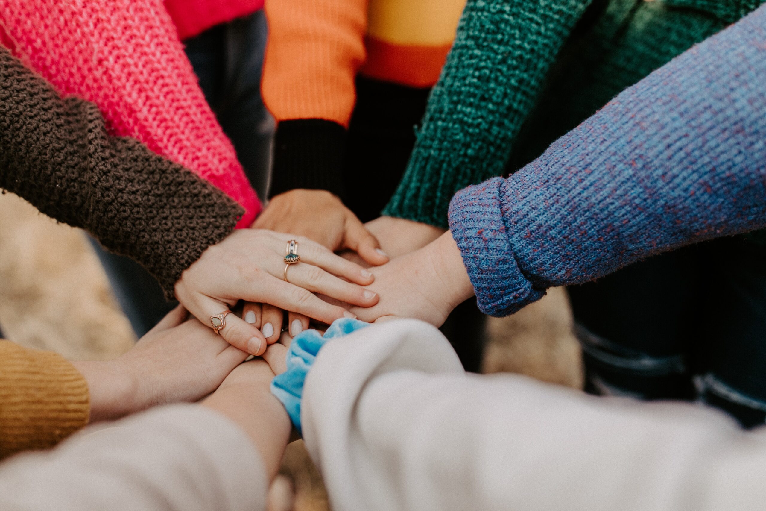 Group of people with hands together in a circle