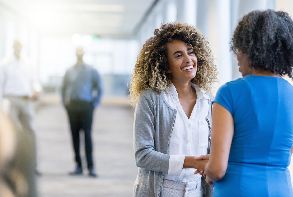 Two women shaking hands