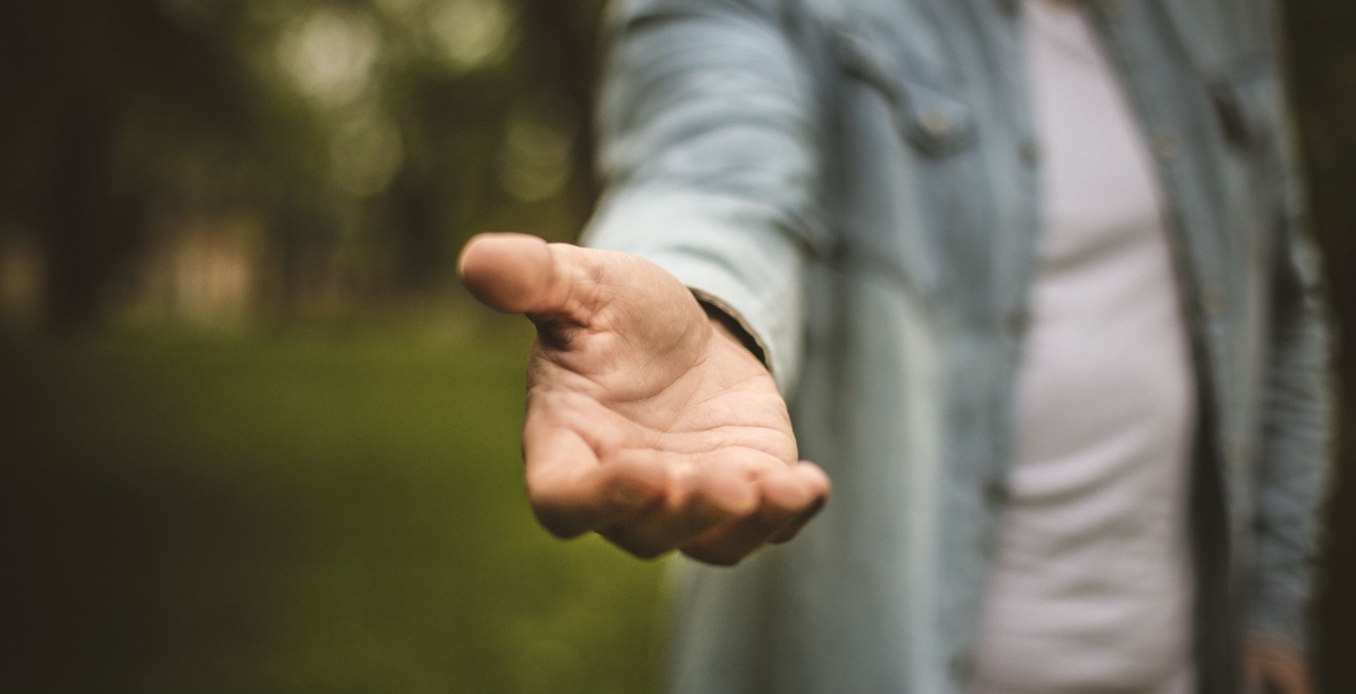 Man extending hand toward camera