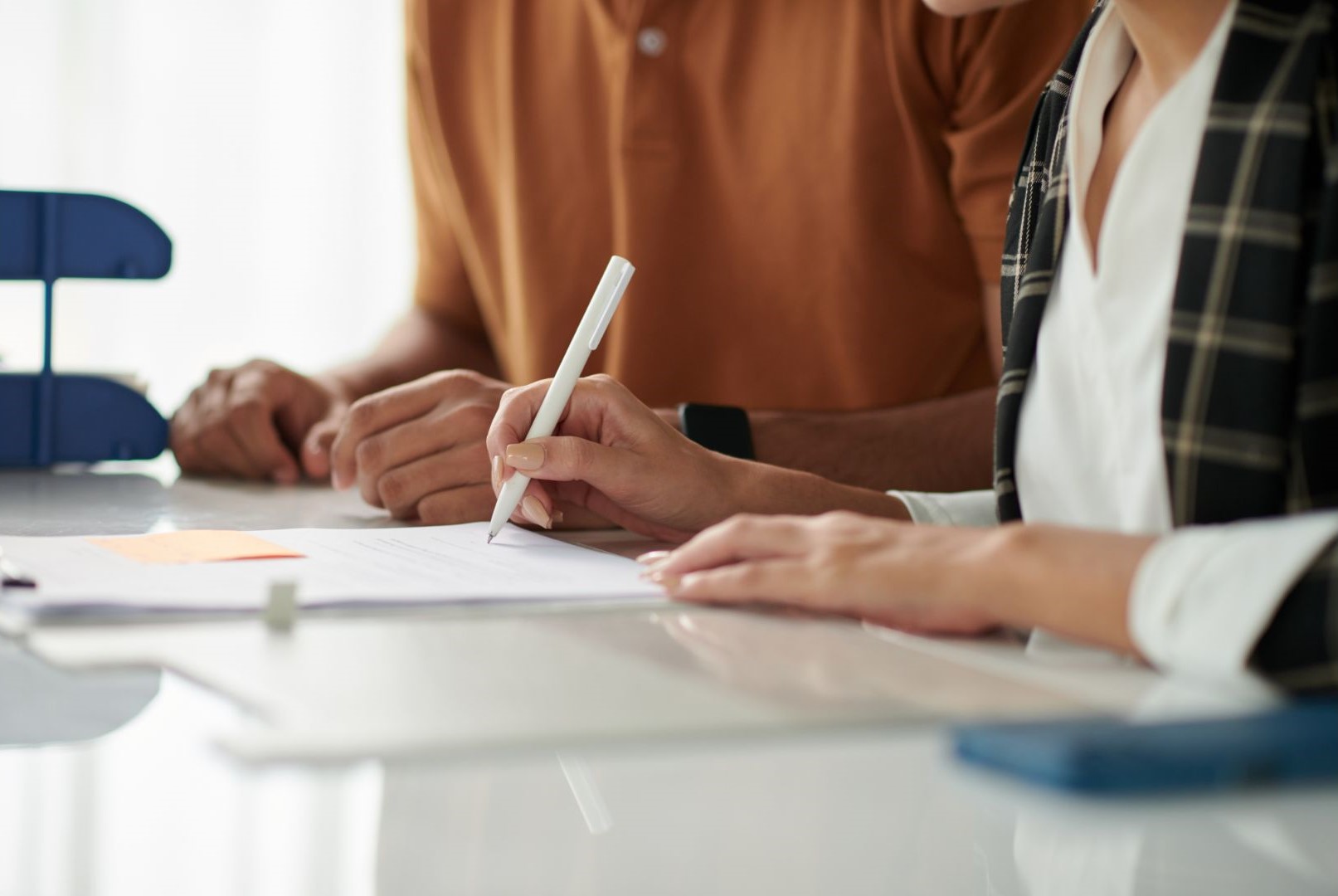 Two people signing documents