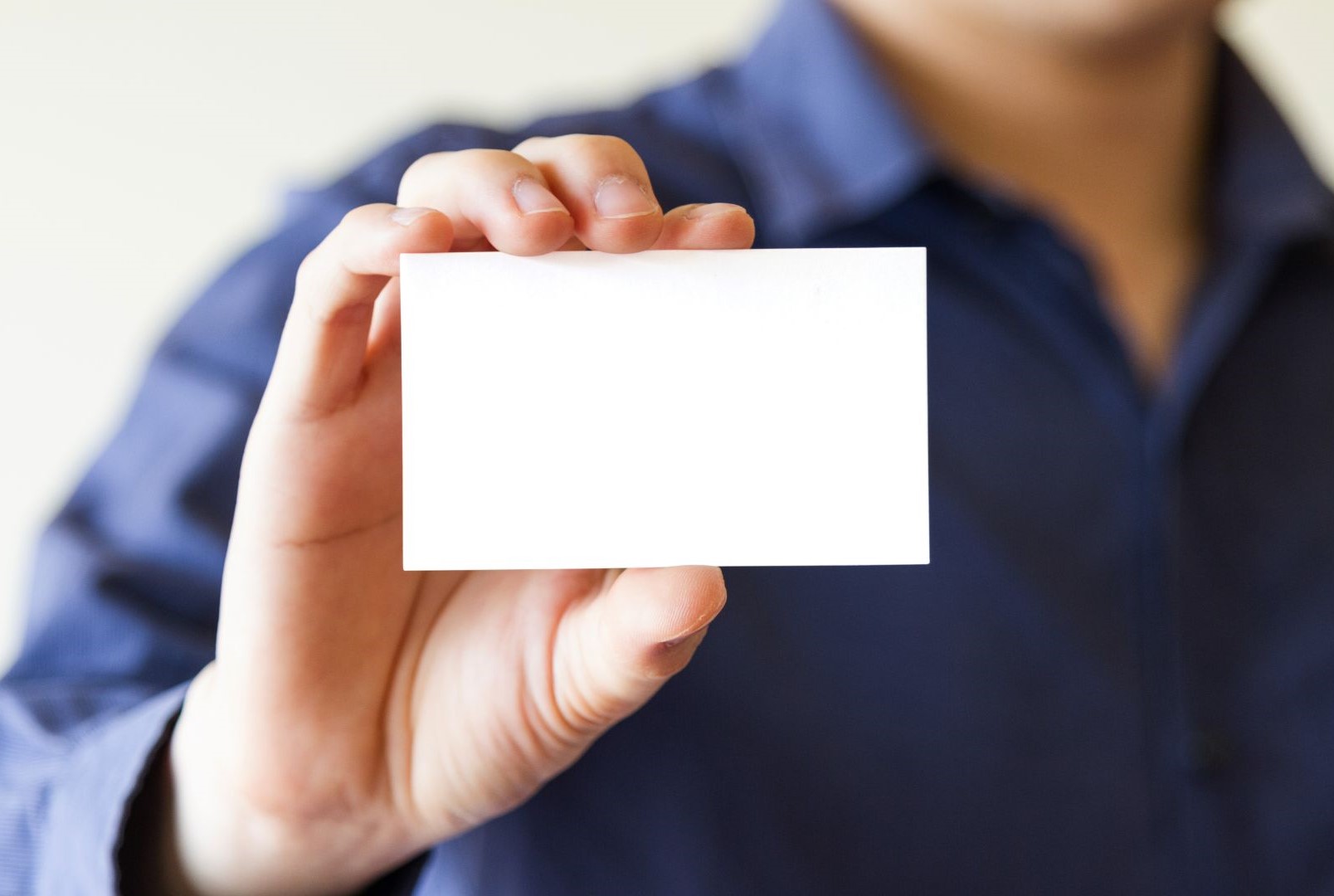 Hand holding a business card